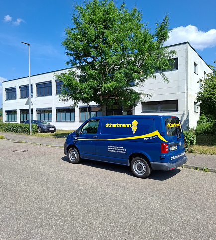 Dr. Hartmann company vehicle in front of company building